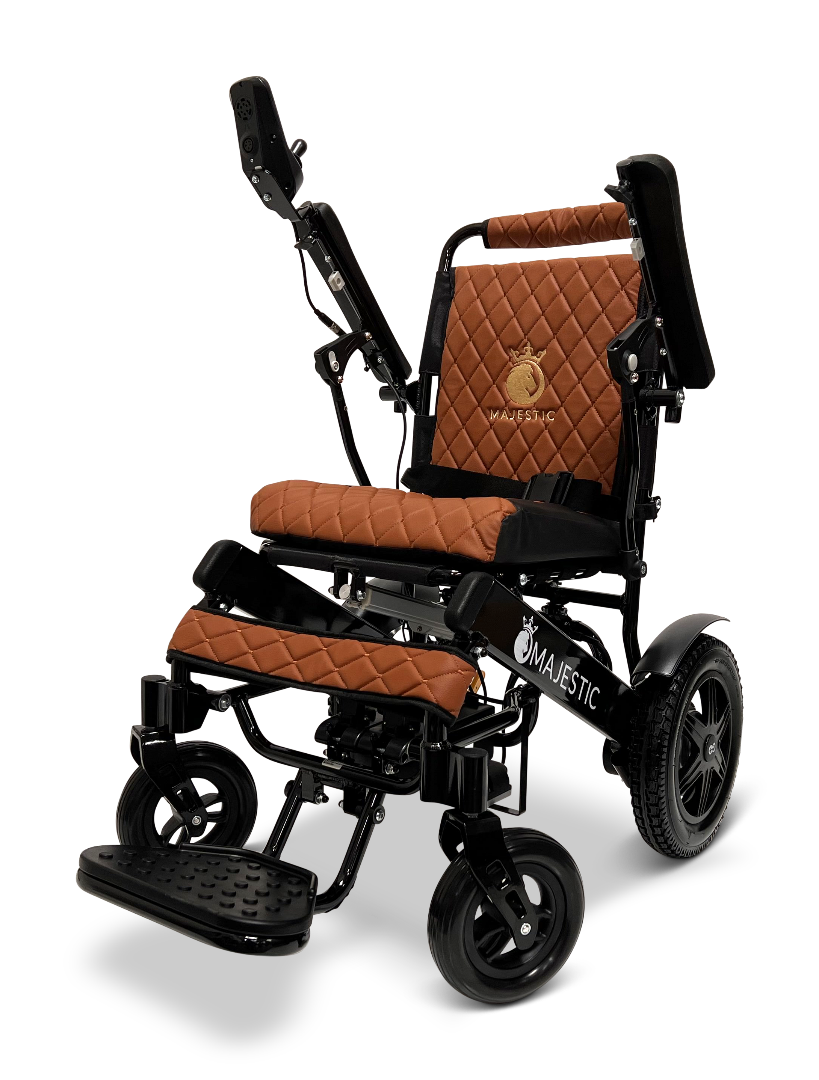The ComfyGo MAJESTIC IQ-9000 Auto Reclining Electric Wheelchair features brown quilted cushions, a black aircraft-grade aluminum alloy frame, adjustable armrests and footrest, plus the Majestic logo embroidered on the seat back.